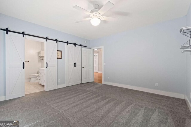 532 Coffee Cove Dr, Jasper, GA 30143 - unfurnished bedroom with a barn door, carpet, and baseboards