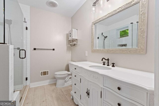 532 Coffee Cove Dr, Jasper, GA 30143 - bathroom with vanity, a stall shower, toilet, wood finished floors, and baseboards