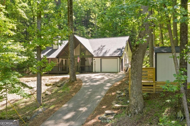 532 Coffee Cove Dr, Jasper, GA 30143 - view of front of property featuring an attached garage, asphalt driveway, a chimney, a porch, and a storage shed
