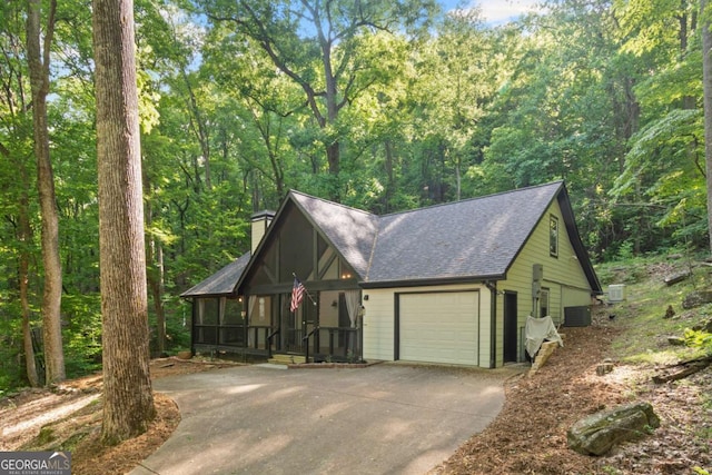 532 Coffee Cove Dr, Jasper, GA 30143 - view of front facade featuring concrete driveway, a shingled roof, a chimney, central AC unit, and a garage