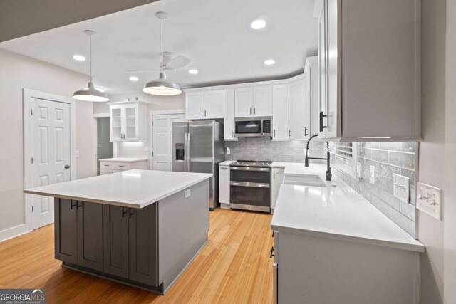 532 Coffee Cove Dr, Jasper, GA 30143 - kitchen with stainless steel appliances, a ceiling fan, white cabinets, tasteful backsplash, and recessed lighting