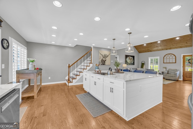 1035 Mcfarlin Bridge Rd, Carnesville, GA 30521 - kitchen with dishwasher, recessed lighting, open floor plan, white cabinets, and light wood finished floors