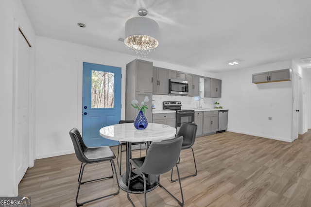 2030 Euclid St, Statham, GA 30666 - dining space featuring light wood-style floors and a chandelier