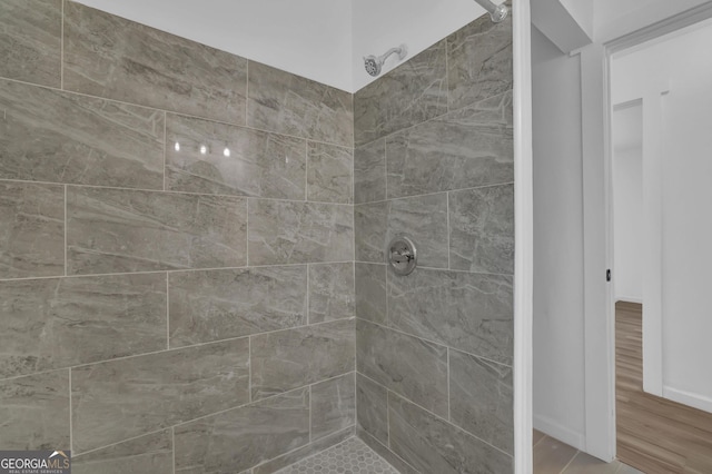 2030 Euclid St, Statham, GA 30666 - bathroom featuring tiled shower and wood finished floors
