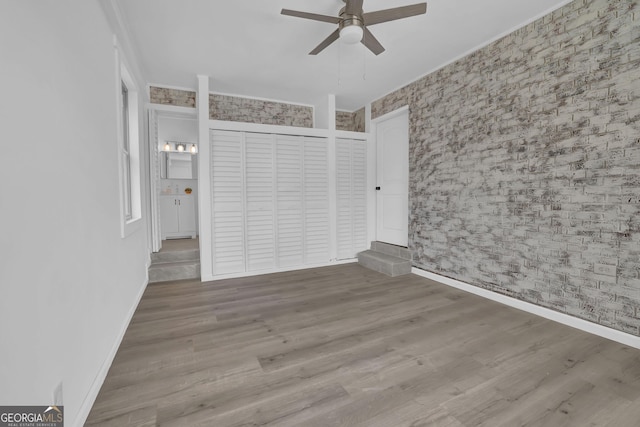 2030 Euclid St, Statham, GA 30666 - unfurnished bedroom featuring wallpapered walls, wood finished floors, and a ceiling fan