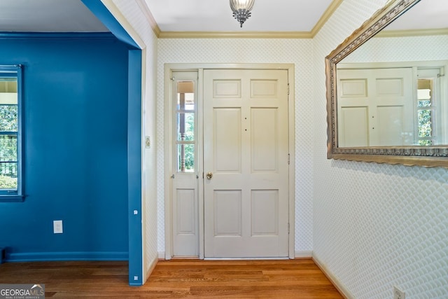 7121 Forest Dr SE, Covington, GA 30014 - entrance foyer with wallpapered walls, ornamental molding, and wood finished floors