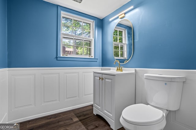 7121 Forest Dr SE, Covington, GA 30014 - half bathroom with wainscoting, vanity, and wood finished floors