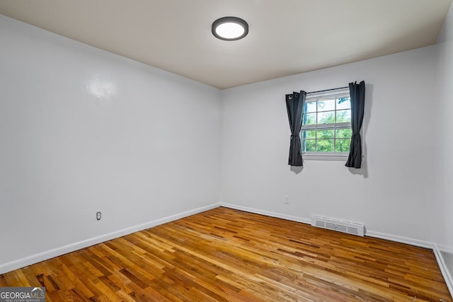 7121 Forest Dr SE, Covington, GA 30014 - spare room with wood finished floors