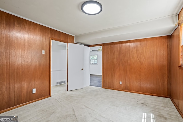 7121 Forest Dr SE, Covington, GA 30014 - carpeted empty room featuring wooden walls, ceiling fan, and crown molding