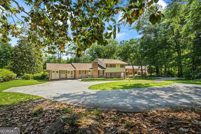 7121 Forest Dr SE, Covington, GA 30014 - tri-level home with curved driveway and view of wooded area