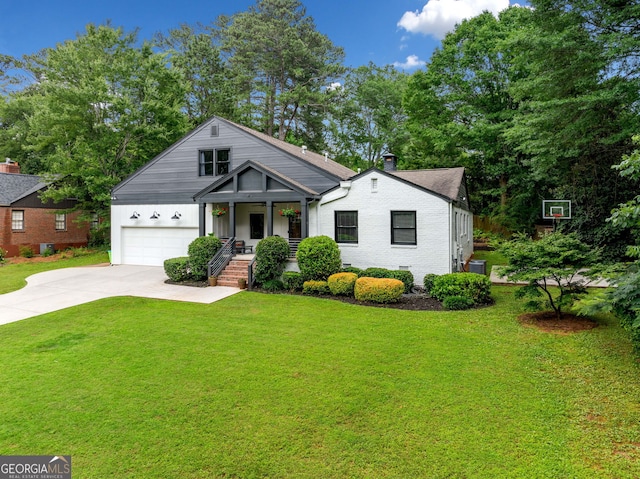 916 Stratford Rd, Avondale Estates, GA 30002 - view of front of home with covered porch, driveway, a front lawn, a garage, and central AC unit
