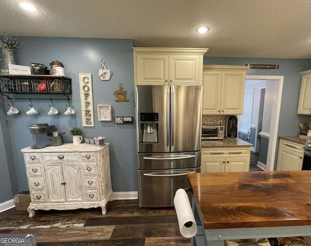 40 Legend Creek Chase, Douglasville, GA 30134 - kitchen with stainless steel fridge with ice dispenser, cream cabinetry, a textured ceiling, dark wood-style flooring, and baseboards
