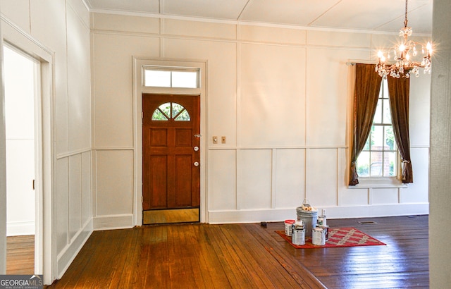 100 Minor Ave, Montezuma, GA 31063 - foyer featuring a decorative wall, plenty of natural light, dark wood-type flooring, a chandelier, and crown molding