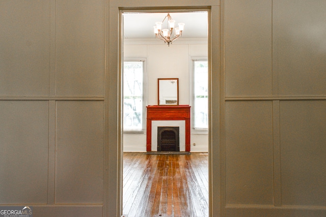 100 Minor Ave, Montezuma, GA 31063 - hall with a chandelier, hardwood / wood-style flooring, a decorative wall, and crown molding