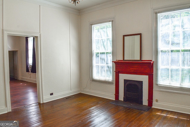 100 Minor Ave, Montezuma, GA 31063 - unfurnished living room with hardwood / wood-style floors, baseboards, a fireplace, and crown molding