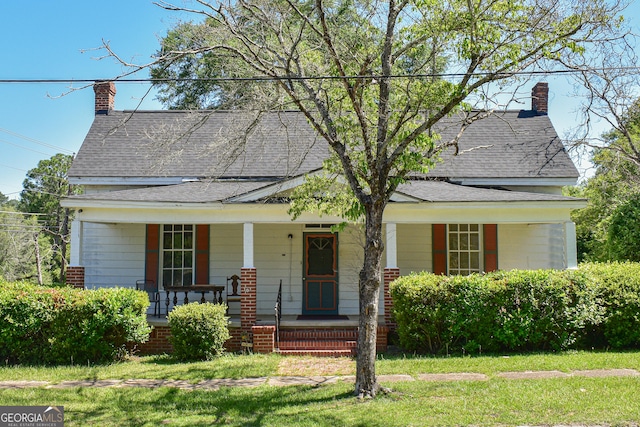 100 Minor Ave, Montezuma, GA 31063 - view of front of property with a porch, a shingled roof, a chimney, and a front lawn