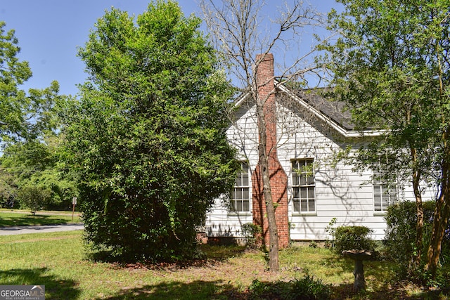 100 Minor Ave, Montezuma, GA 31063 - view of property exterior featuring a chimney and a lawn