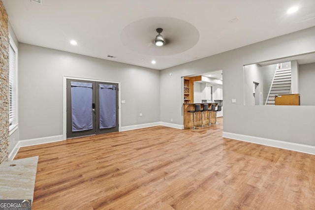 2230 Ewing Chapel Rd, Dacula, GA 30019 - unfurnished living room with stairway, ceiling fan, wood finished floors, recessed lighting, and french doors