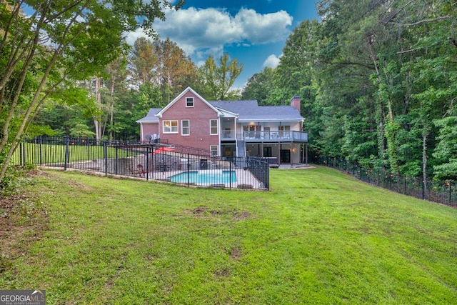 2230 Ewing Chapel Rd, Dacula, GA 30019 - back of property featuring a chimney, a fenced backyard, a patio area, a deck, and brick siding