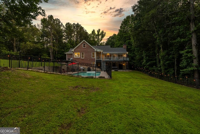 2230 Ewing Chapel Rd, Dacula, GA 30019 - back of house at dusk featuring a deck and a chimney