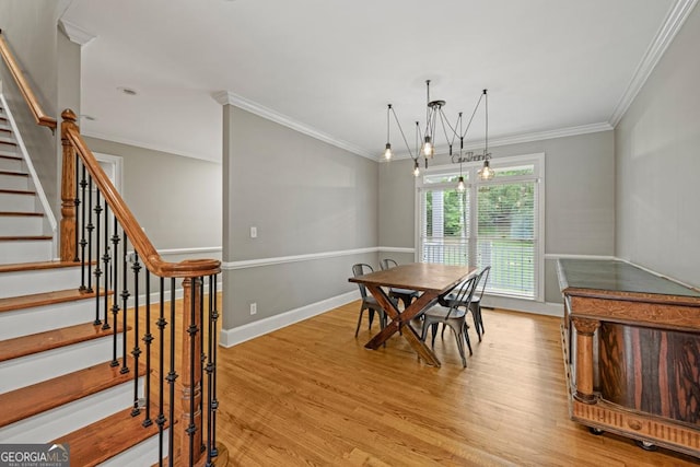2230 Ewing Chapel Rd, Dacula, GA 30019 - dining area featuring light wood-style floors, stairs, crown molding, and a chandelier