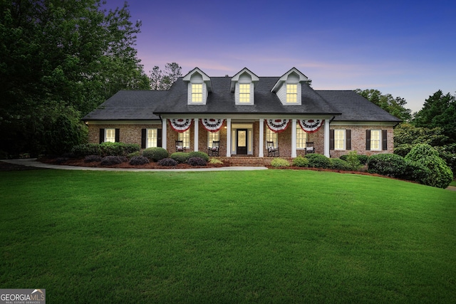 704 Branchview Ct, Mcdonough, GA 30252 - cape cod home featuring a lawn, brick siding, a porch, and a shingled roof