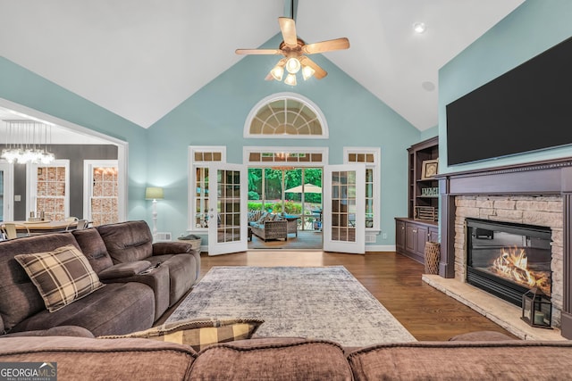 704 Branchview Ct, Mcdonough, GA 30252 - living room with high vaulted ceiling, a chandelier, a fireplace, ceiling fan, and wood finished floors