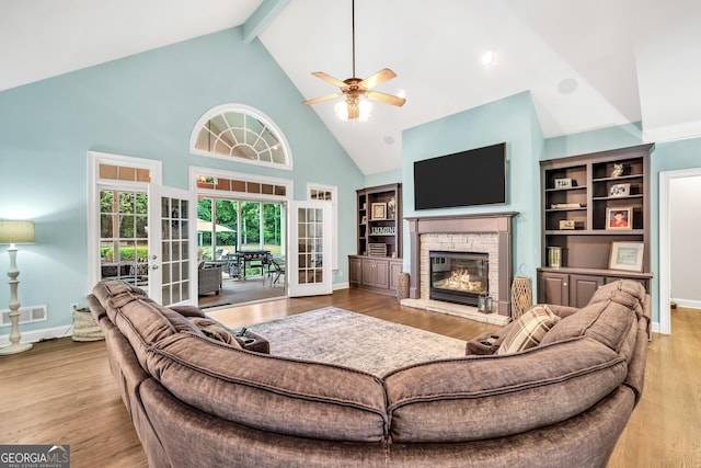 704 Branchview Ct, Mcdonough, GA 30252 - living area featuring high vaulted ceiling, ceiling fan, a fireplace, beamed ceiling, and baseboards