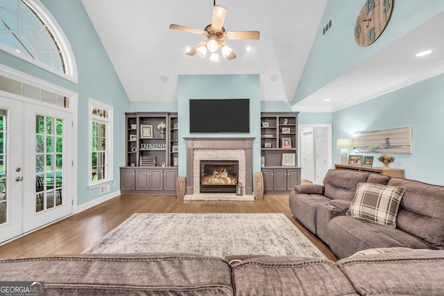 704 Branchview Ct, Mcdonough, GA 30252 - living room with wood finished floors, high vaulted ceiling, a fireplace, ceiling fan, and french doors