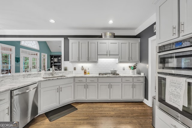 704 Branchview Ct, Mcdonough, GA 30252 - kitchen with appliances with stainless steel finishes, a sink, backsplash, wood finished floors, and ornamental molding