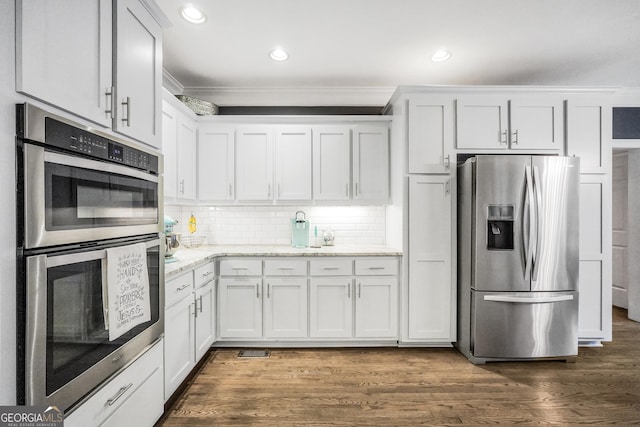 704 Branchview Ct, Mcdonough, GA 30252 - kitchen featuring appliances with stainless steel finishes, crown molding, light stone countertops, white cabinets, and recessed lighting