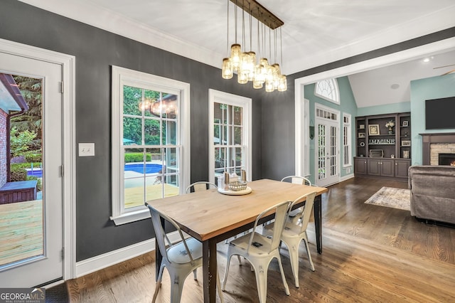 704 Branchview Ct, Mcdonough, GA 30252 - dining space with baseboards, vaulted ceiling, a chandelier, healthy amount of natural light, and wood finished floors