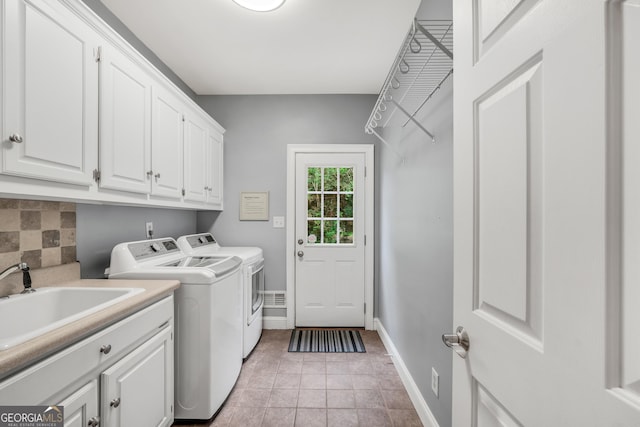 704 Branchview Ct, Mcdonough, GA 30252 - laundry area featuring separate washer and dryer, cabinet space, and baseboards
