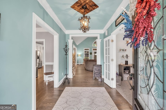 704 Branchview Ct, Mcdonough, GA 30252 - foyer entrance featuring french doors, a chandelier, dark wood-style flooring, baseboards, and ornamental molding