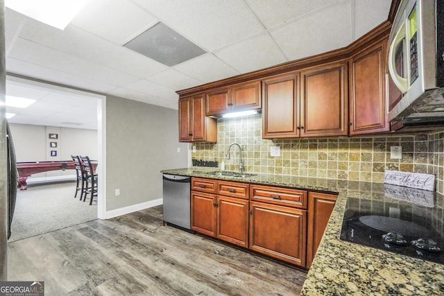 704 Branchview Ct, Mcdonough, GA 30252 - kitchen featuring appliances with stainless steel finishes, a sink, wood finished floors, a paneled ceiling, and tasteful backsplash