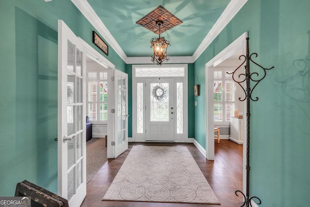 704 Branchview Ct, Mcdonough, GA 30252 - entrance foyer featuring french doors, crown molding, a chandelier, dark wood finished floors, and baseboards