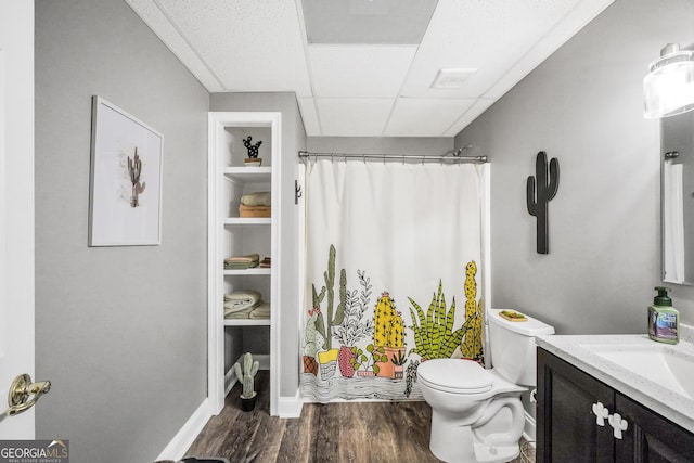 704 Branchview Ct, Mcdonough, GA 30252 - bathroom featuring vanity, toilet, wood finished floors, curtained shower, and a drop ceiling