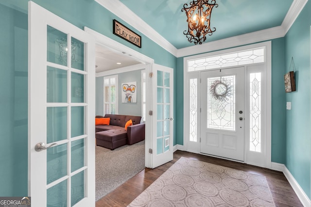 704 Branchview Ct, Mcdonough, GA 30252 - entrance foyer featuring ornamental molding, french doors, a chandelier, baseboards, and wood finished floors