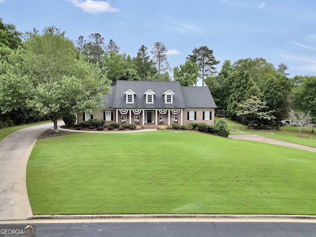 704 Branchview Ct, Mcdonough, GA 30252 - cape cod-style house featuring a front lawn, a porch, and view of scattered trees