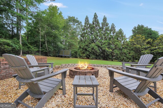 704 Branchview Ct, Mcdonough, GA 30252 - view of patio / terrace with a fire pit and a trampoline