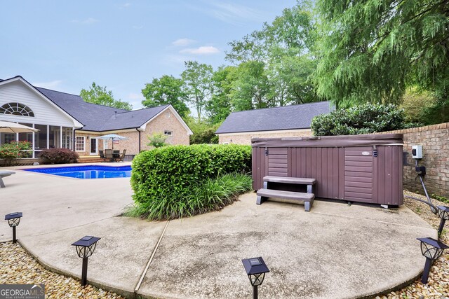 704 Branchview Ct, Mcdonough, GA 30252 - view of pool featuring a hot tub, a patio area, and a sunroom