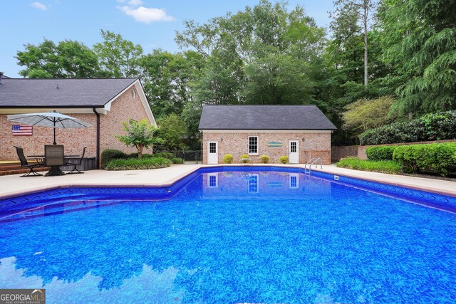 704 Branchview Ct, Mcdonough, GA 30252 - view of pool with a patio area and an outdoor structure