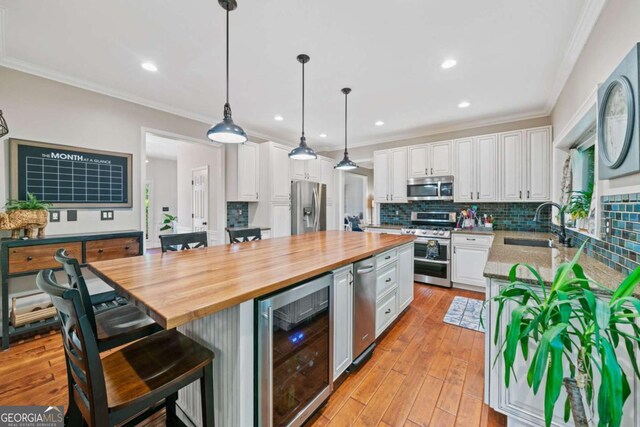 2346 Unicoi Ct, Duluth, GA 30097 - kitchen featuring stainless steel appliances, beverage cooler, butcher block counters, white cabinets, and a kitchen island
