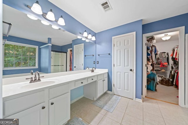 2346 Unicoi Ct, Duluth, GA 30097 - bathroom featuring double vanity, a spacious closet, a stall shower, tile patterned flooring, and baseboards