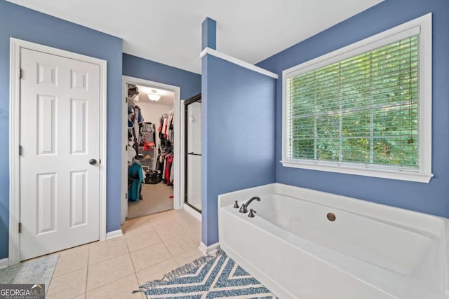 2346 Unicoi Ct, Duluth, GA 30097 - bathroom with a garden tub, a walk in closet, a shower stall, baseboards, and tile patterned floors