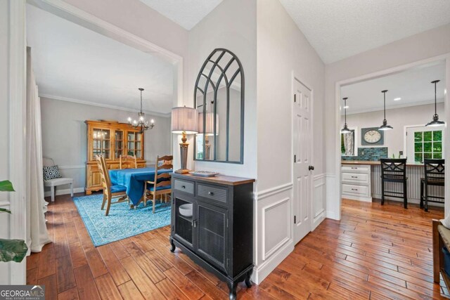 2346 Unicoi Ct, Duluth, GA 30097 - hall featuring hardwood / wood-style flooring, a chandelier, and crown molding