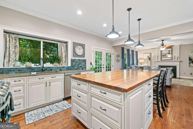 2346 Unicoi Ct, Duluth, GA 30097 - kitchen with appliances with stainless steel finishes, butcher block countertops, a sink, french doors, and crown molding