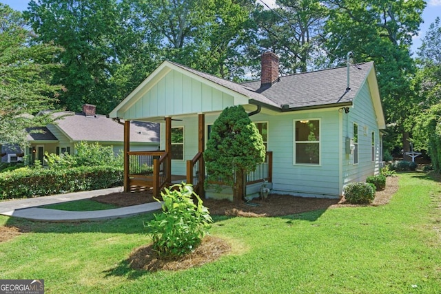 5 Windsor Ter, Avondale Estates, GA 30002 - bungalow-style home featuring a porch, board and batten siding, a front yard, and a chimney