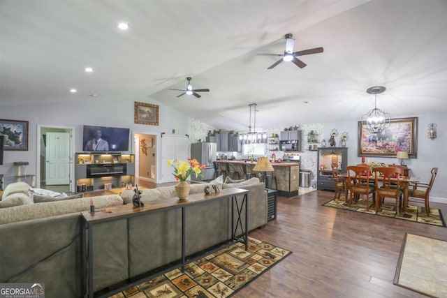 287 Napier Dr, Eatonton, GA 31024 - living area with a ceiling fan, a chandelier, vaulted ceiling, dark wood-style flooring, and recessed lighting