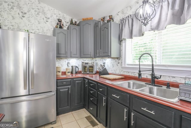 287 Napier Dr, Eatonton, GA 31024 - kitchen with freestanding refrigerator, wallpapered walls, a sink, and light tile patterned flooring